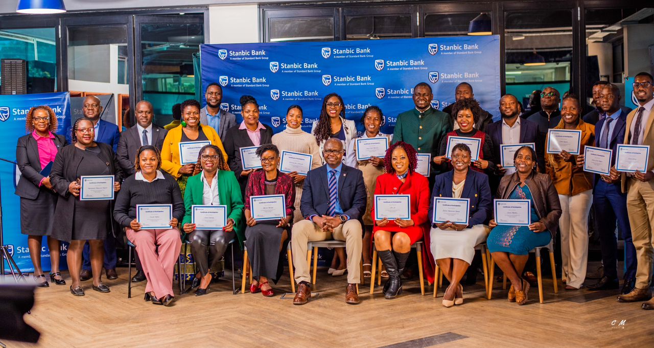 CAPTION: Stanbic Bank Chairman, Much Mkanganwi (seated centre), Stanbic Executives and some of the entrepreneurs proudly displaying their certificates after the clinic.