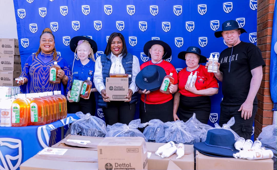 ALCOZ Founder, Loveness Mainato (left) and Stanbic Bank Head of Brand and Marketing, Tariro Memo (third from left) are joined by some of the ALCOZ members at the handover event.